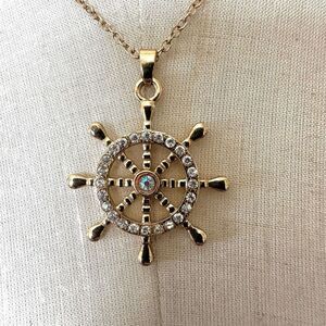 Gold tone and rhinestone ships wheel pendant necklace